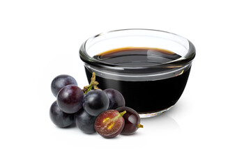 black grape and grape molasses in glass bowl isolated on white background.
