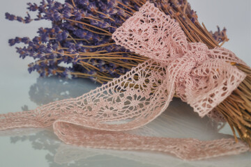 Dried lavender flowers and a pink lace ribbon
