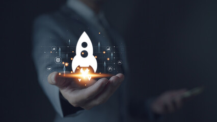 Startup business concept, businessman holds rocket icon and up arrow to start business quickly....