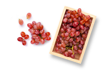Red grapes in wooden box isolated on white background. Top view. Flat lay. 