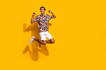 Fototapeta na wymiar Full length photo of funny confident man wear print t-shirt jumping high showing thumbs himself empty space isolated yellow color background