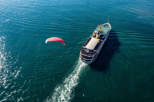 Aerial view of paramotor flying over a ferry boat in Marmara Sea, Istanbul, Turkey.