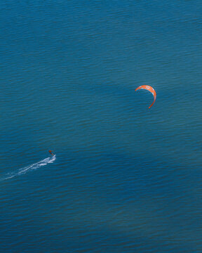 Aerial view of a kiter into the sea in Sicily, Italy.