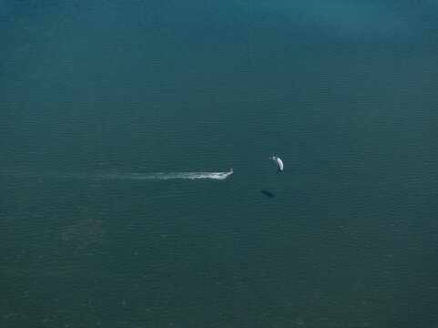 Aerial view of a kiter into the sea in Sicily, Italy.