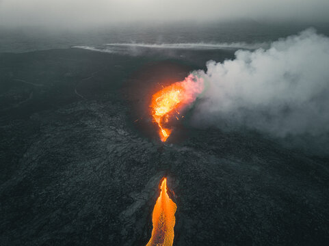 Aerial view of a lava explosion and the fog in Iceland.