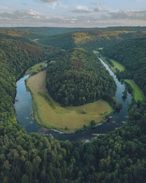 Aerial view of Bouillon with lush forest and riverbend, Bouillon, Belgium.