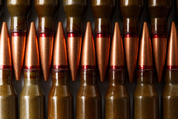 Bullets for firearms, live military cartridges, close-up, military background