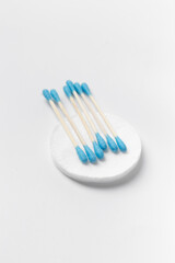 Cotton swabs buds and cotton pads on a white background.