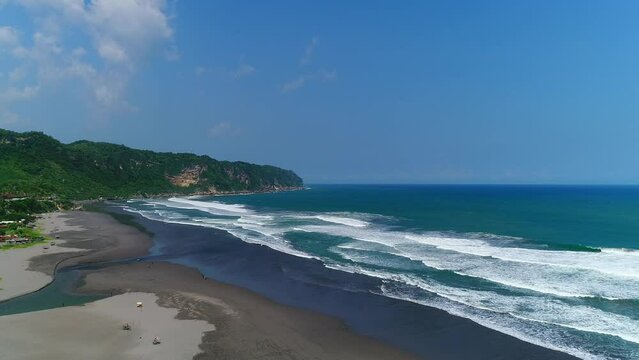 Aerial view of parangtritis beach in yogyakarta, indonesia. parangtritis beach footage with eye bird view from drone. 