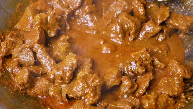 Close-up of beef rendang in the making, a popular traditional indonesian dish. Selective focus