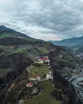 Aerial view of Sabiona Monastery and Chiusa town with beautiful countryside and vineyards, Klausen, South Tyrol, Italy.