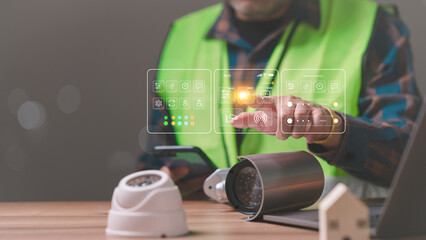 A engineer man is using a cell phone and touching a virtual screen that has a camera on it. The man is wearing a green vest