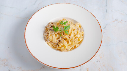 Fettuccine alfredo in plate isolated