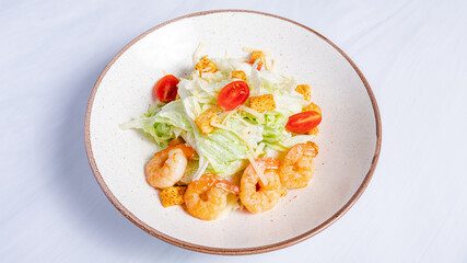 Shrimps Caesar salad bowl top view