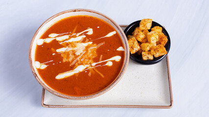 Tomato soup with crackers isolated on white