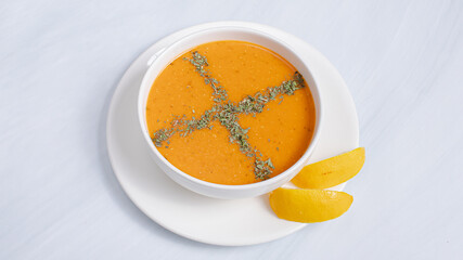 Turkish lentil soup with lemon slice isolated on white