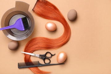 Hair strand with hairdressing accessories and Easter eggs on light brown background