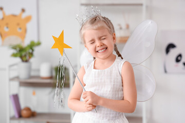 Cute little girl dressed as fairy at home