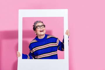 Photo portrait of lovely senior lady look empty space photo frame wear trendy blue striped garment...