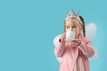 Cute little fairy drinking tea on blue background