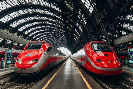 Milan, Italy - 2 January 2024: Two symmetrically situated FrecciaRossa trains at a station in Milan