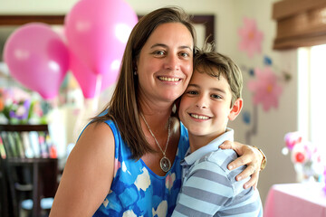 Portrait of a mother and her son in a home scene during Mother's Day celebration with balloons and party stuff in the background