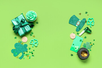 Gift box with cupcake and decor for St. Patrick's Day on green background