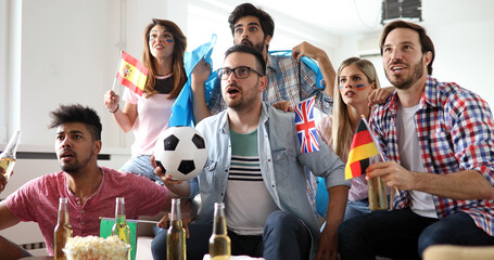 Shocked, frustrated friends watching football game at home - 763275230