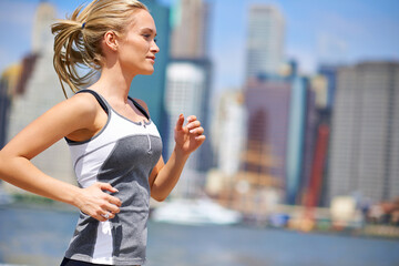 Woman, strong and running for fitness in city, jogging active and fit female person exercising in...