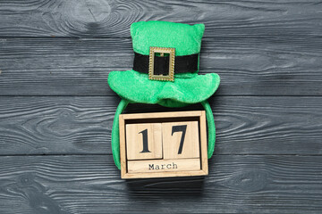 Leprechaun hat with calendar on grey wooden background. St. Patrick's Day celebration
