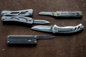 Four different knives on brown background