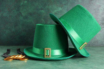 Leprechaun hats with coins and horseshoe on green grunge background. St. Patrick's Day celebration