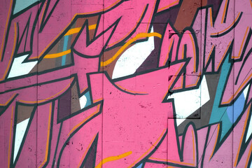 Colorful background of graffiti painting artwork with bright aerosol outlines on wall. Old school...