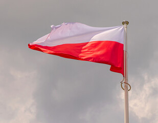 White and Red National Flag of Poland at Clouds
