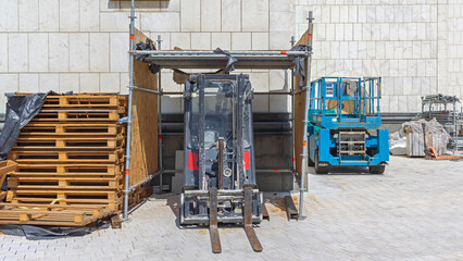Stack of Wooden Pallets Forklift in Scaffoldings Garage Platform Construction Site