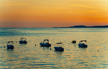 Many boats at sunset in the bay. - 763285455