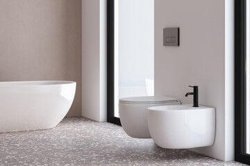 A bathroom with a white toilet and a white bathtub. The toilet is a wall-mounted bidet - obrazy, fototapety, plakaty