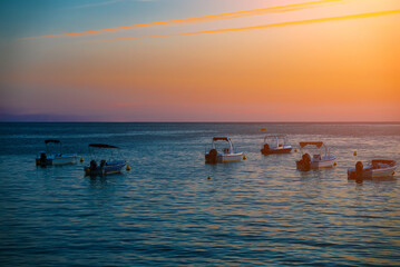 Many boats at sunset in the bay. - 763285474