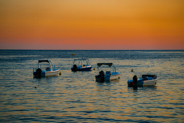 Many boats at sunset in the bay. - 763285489