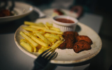 Nuggets and fries in a restaurant. Junk food. - 763285493