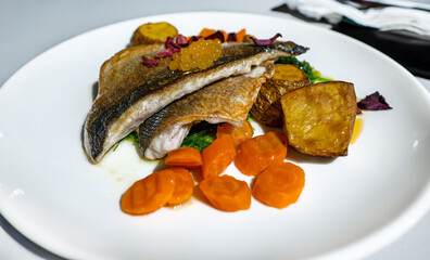 Seabass fillet with potatoes in a restaurant. - 763285494