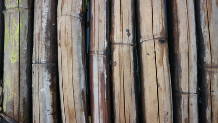 The texture under the background of dried bamboo is grey, vertically positioned.