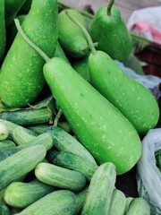Cucumbers and squashes for sale at a farmers market.