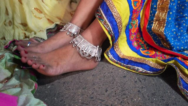 Closeup of Women Foot Anklets jewelry. Indian women in traditional clothing Wearing Silver Ankle Bracelet or Payal Fashion Accessories.