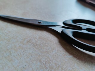 Scissors on the table. Shallow depth of field. Selective focus.