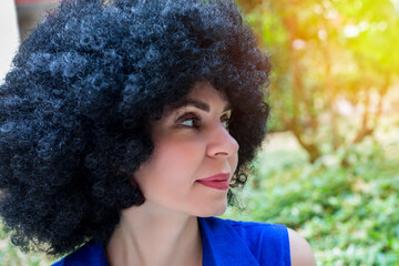 Portrait of beautiful woman with curly hair extensions.