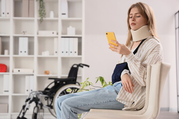 Injured young woman with mobile phone after accident waiting for her turn in clinic