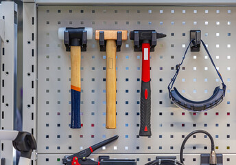 Three Different Hammers and Safety Goggles at Rack Tools Organization