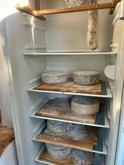 fridge with natural cheeses, homemade long-ripened cheeses, homemade salami, long-ripened products in the home refrigerator