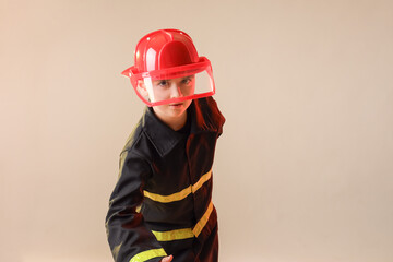Cute little firefighter on light background